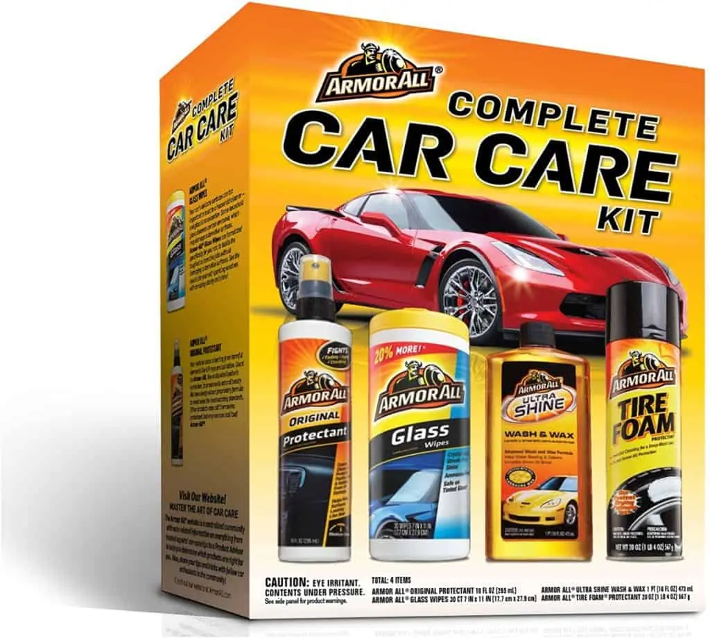 A product image featuring Armor All's complete car kit box that contains a can of sprayable tire foam, a bottle of "ultra shine wash & wax," a container of glass wipes, and a spray bottle labeled "original protectant" for use in the car's interior. 