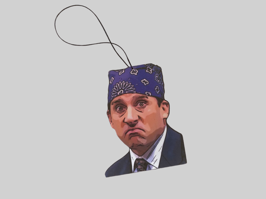 A product image for a car air freshener designed to look like Prison Mike from the office. 