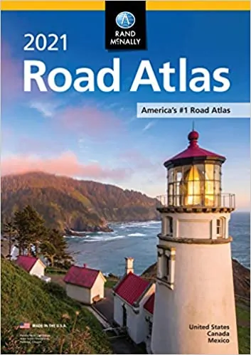 The cover of the 2121 Road Atlas, featuring a lighthouse near the water and some mountains, and the claim "America's #1 Road Atlas" printed on the cover. 