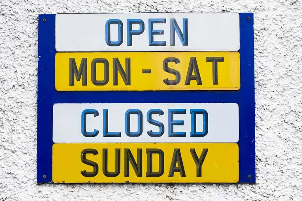 Dealership Hours Sign. Open: Monday - Saturday. Closed: Sunday.
